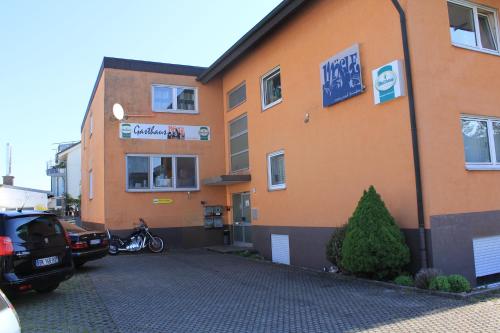 a building with a motorcycle parked in front of it at Gasthaus Mösle in Reute