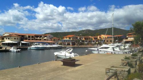 a group of boats docked in a marina with houses at Appartamento Ottiolu Mare in Porto Ottiolu