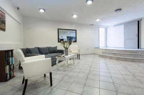 a living room with a couch and a table at Thomais Studios in Naxos Chora