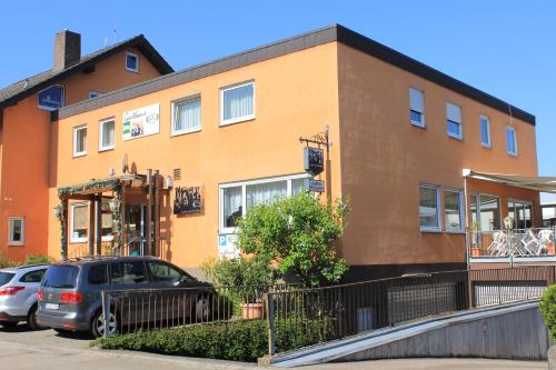 a building with cars parked in front of it at Gasthaus Mösle in Reute