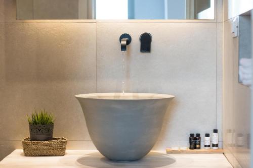 a bathroom with a water fountain in a bowl at Thomais Studios in Naxos Chora