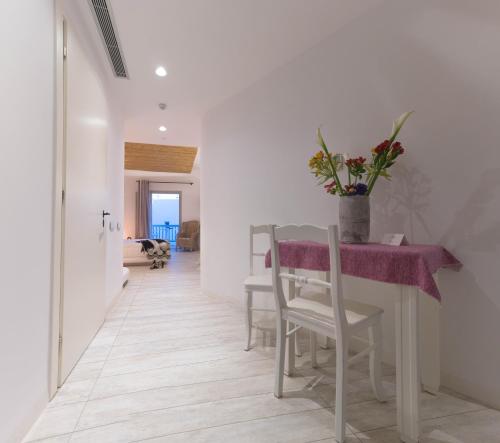 a dining room with a table with a purple table cloth at Thomais Studios in Naxos Chora
