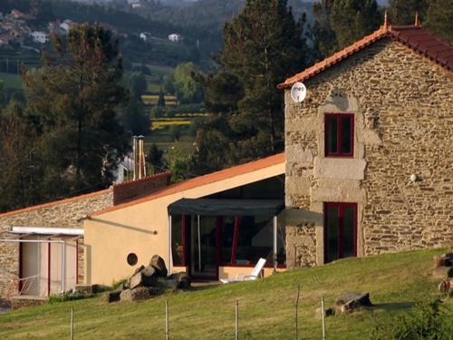 a stone house on a hill with a view at Quinta da Cerdeira in Seia