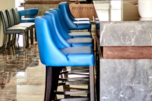 a row of blue chairs in a store at The District Hotel in St Julian's