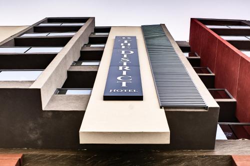 a building with a sign on the side of it at The District Hotel in St Julian's