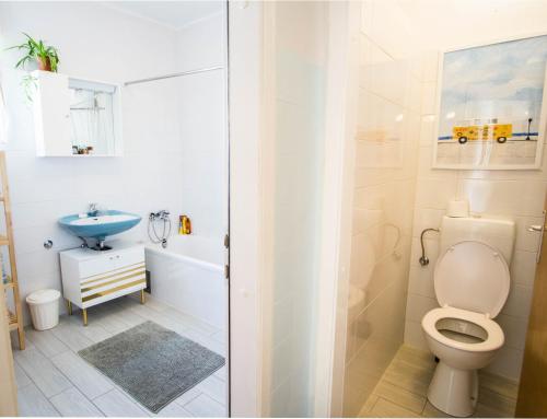 a bathroom with a toilet and a sink at Spacious apartment by the sea 8+4 in Pula