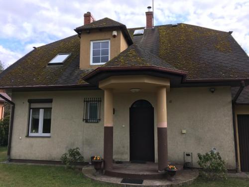 a house with a black door at Family House Gowidlino in Gowidlino