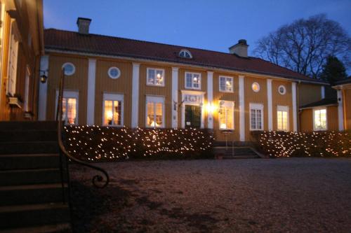 a building with christmas lights in front of it at Forsbacka Wärdshus in Forsbacka