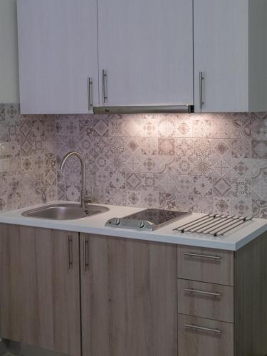 a kitchen with a sink and a counter top at FiscardoStudios in Fiskardho