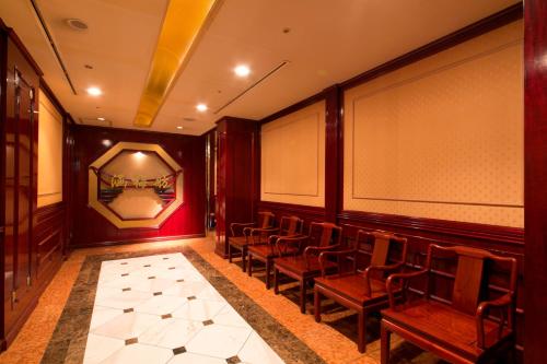a room with chairs and a wall with a mirror at Meitetsu Grand Hotel in Nagoya