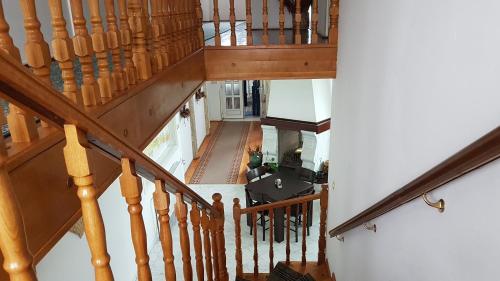 an overhead view of a staircase with wooden railings at Guest House Luxotel in Zrenjanin