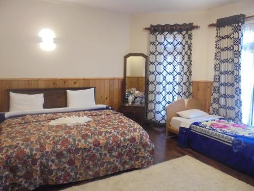 a bedroom with a bed and a chair in it at The Hill Town Cottage in Nuwara Eliya