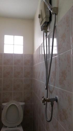 a shower in a bathroom with a toilet at Blue Mountain Resort in Sai Yok