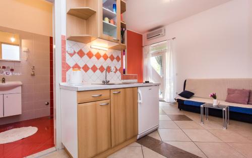 a kitchen with a sink and a counter top at Apartments Kraljić in Baška