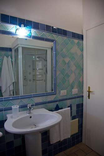 a bathroom with a sink and a mirror at Bados Mare in Olbia