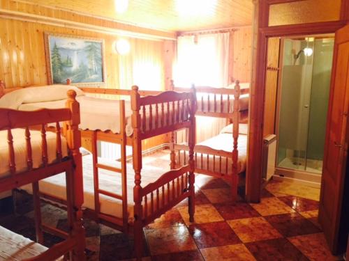 a room with two bunk beds and a window at Bungalows & Albergue La Playa in Logroño