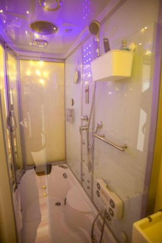 a bathroom with a toilet and a purple lighting at Two Top Central Artisan Beach Studios - separate Spa Cabin in Brighton & Hove