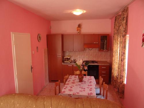 a kitchen with a table and a dining room at Apartments Jerković in Stari Grad
