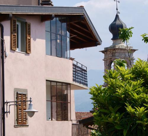 a building with a clock tower in the background at Albergo Diffuso Vulcano Village in Castro