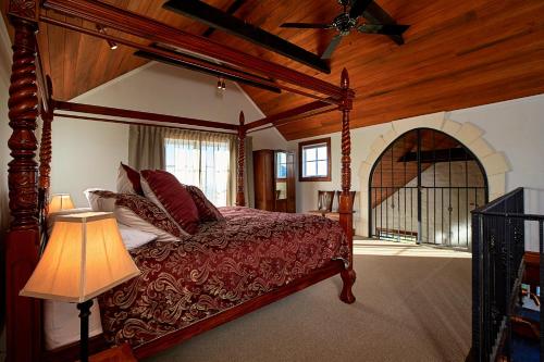 a bedroom with a canopy bed and a lamp at Sky Harbour in Kaikoura