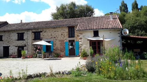 a stone house with a garden in front of it at 17 St Romain in Saulgond