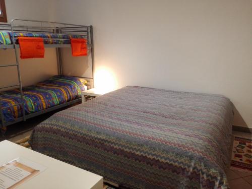 a bedroom with a bed and a bunk bed at B&B Villa Claudia in Lavena Ponte Tresa
