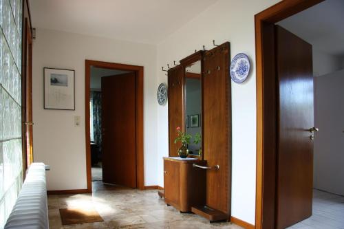 a hallway with two doors with plates on the wall at Villa Ludwig Fewo in Otterndorf