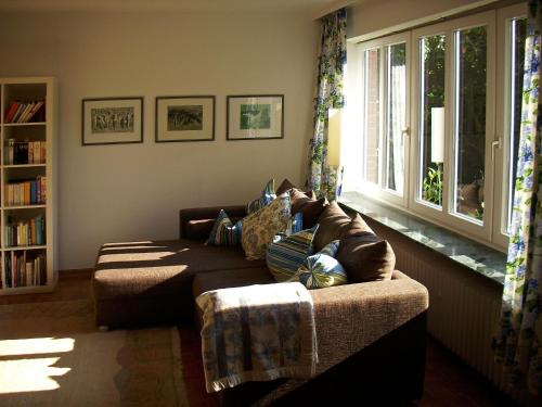 a living room with a couch and a window at Villa Ludwig Fewo in Otterndorf