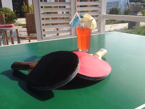 a drink sitting on top of a green table at Paradise Investment Resort in Tʼelavi