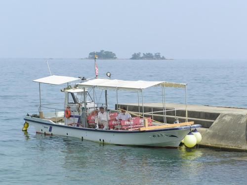 a boat is docked next to a dock at Route Inn Grantia Himi Wakuranoyado in Himi