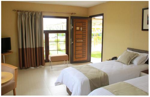 a hotel room with two beds and a balcony at Paradise Investment Resort in Tʼelavi
