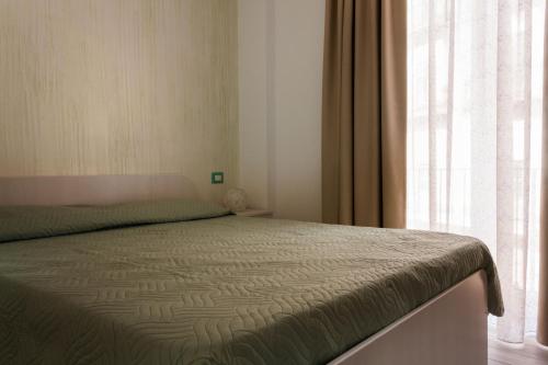 Postel nebo postele na pokoji v ubytování B&B La Piazzetta