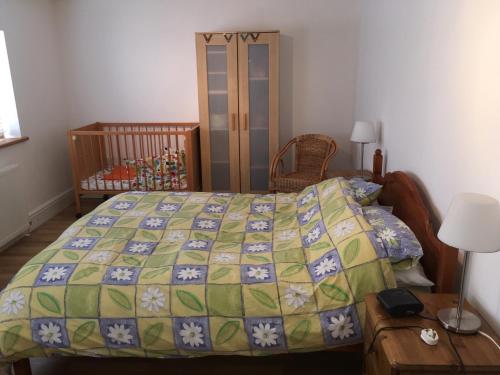 a bedroom with a bed and a crib at Maesbury Riverside in Oswestry