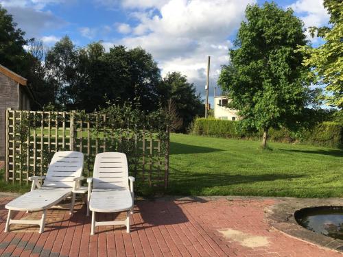 a group of chairs sitting on a brick patio at Maesbury Riverside in Oswestry