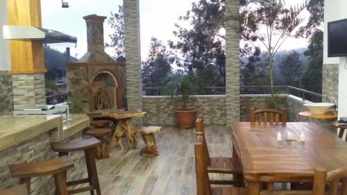 a dining room with a table and a fireplace at Tea Hills Bungalow in Hatton