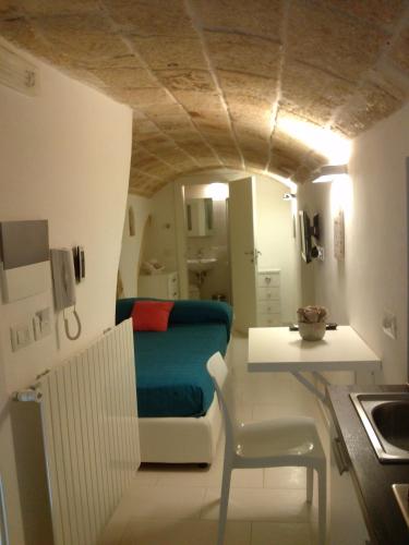 a room with a bed and a table in a room at Le Caravelle Bed and Breakfast in Monopoli