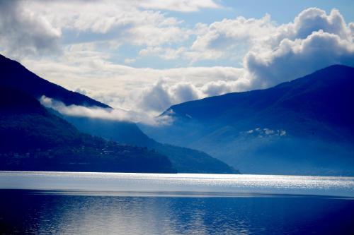 a large body of water with mountains in the background at Ferienwohnung Isabella in Ascona