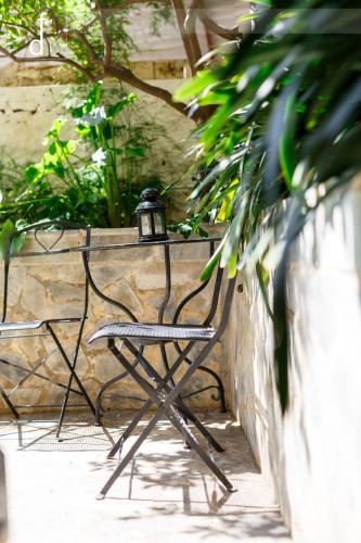 a bench with a light on it next to a wall at Elmar House in Paralion astros