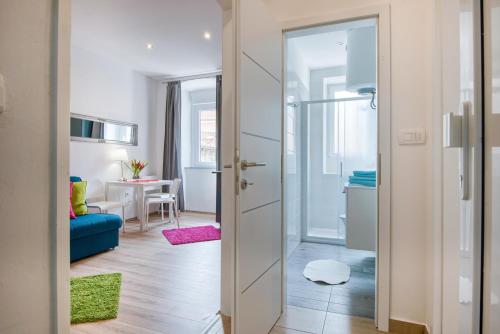 a room with a door open to a living room at Top Center Rooms & Studio in Pula