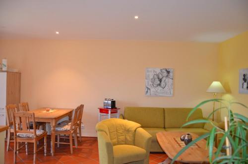 a living room with a couch and a table at Hofgut Wollin GmbH in Putgarten