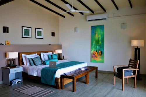 a bedroom with a bed with a laptop on it at Twenty-Two Weligambay in Weligama