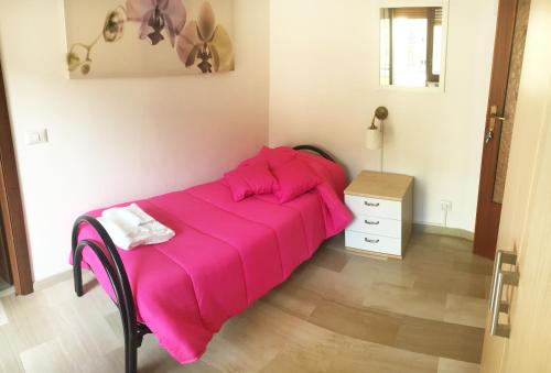 a bed with a pink blanket in a room at B&B Pontepiccolo in Catanzaro