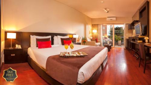 a hotel room with a large bed with red pillows at The Glu Boutique Hotel - Palermo Soho in Buenos Aires