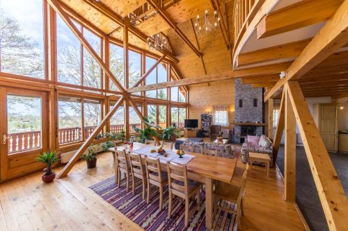 a large dining room with a table and chairs at Carpathian Log Home in Bran