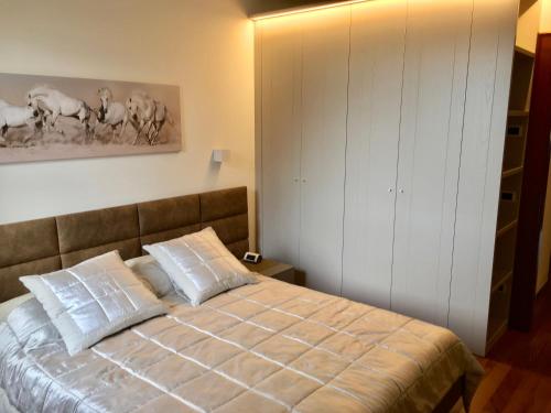 a bedroom with a bed with two pillows at La Loggia Al Duomo - Treviso in Treviso
