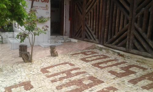 a door of a building with a tile floor in front at Pousada Chalé Suiço in Parnaíba