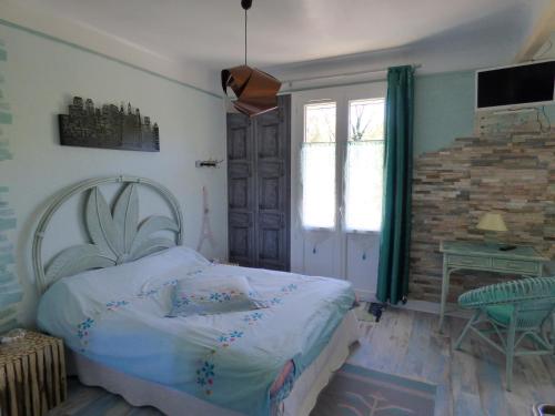 a bedroom with a bed and a fireplace and a window at Beau Site Guimauve et Vieilles Dentelles in Royères-Saint-Léonard