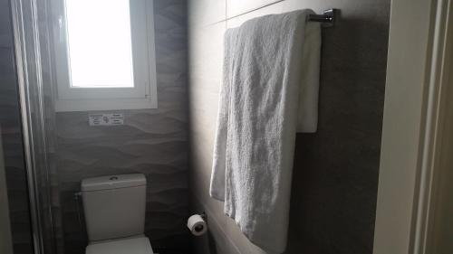 a bathroom with a white towel hanging on the wall at Periyiali Beach Sunset Suite A7 in Pervolia