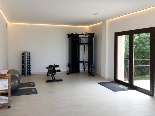 an empty room with a gym with a door at Casa Font i Roig in Maria de la Salut