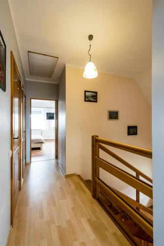 a hallway of a house with a staircase and a light fixture at Holiday Home Ermine in Sigulda
